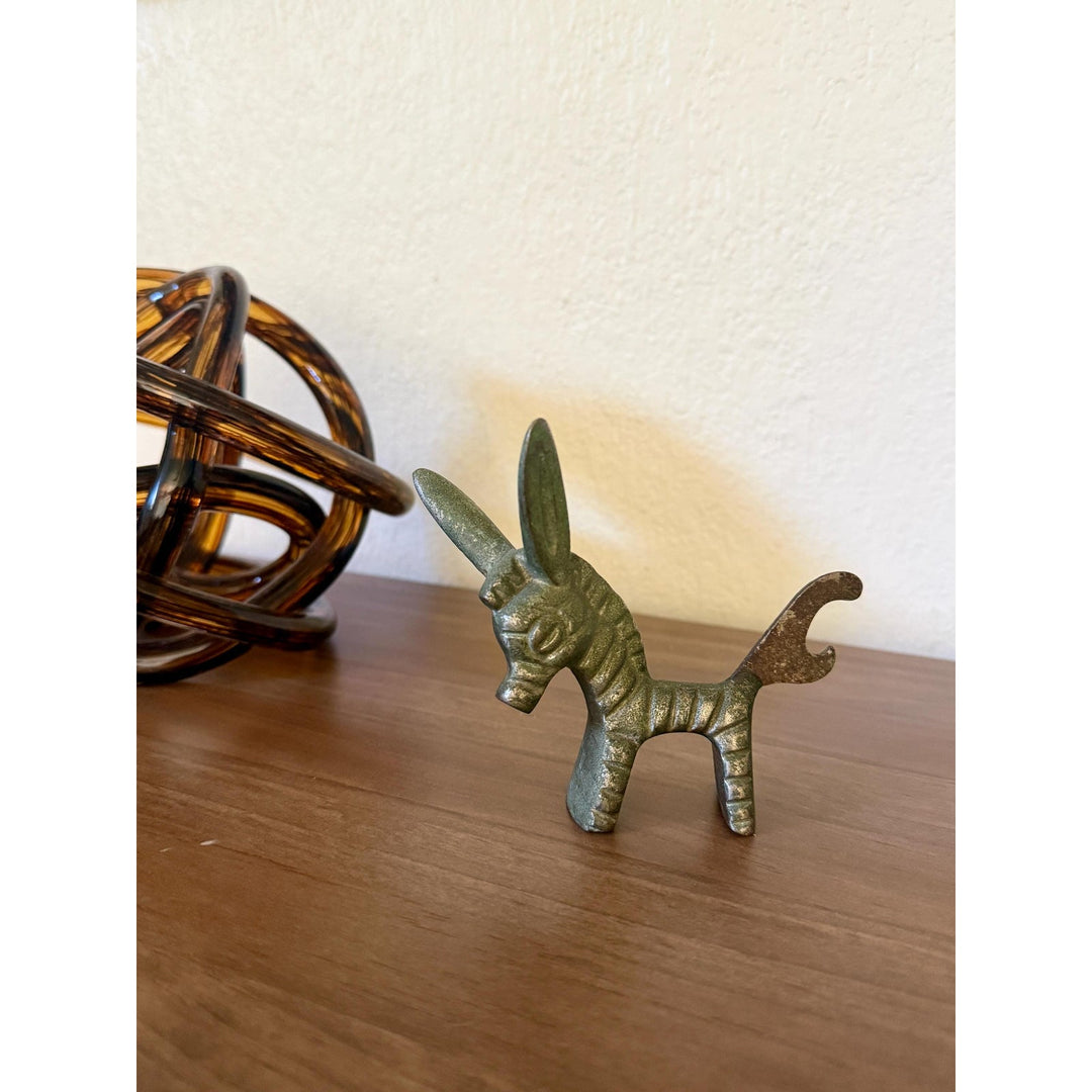 Vintage Walter Bosse brass donkey bottle opener with aged patina and Mid-Century Modern styling.