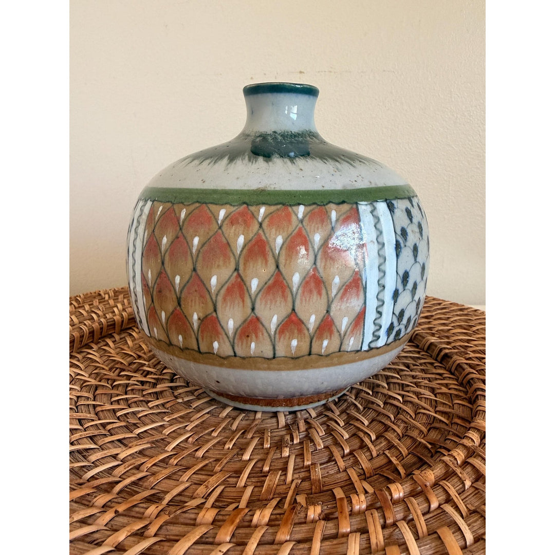 Rounded Erandi Tonalá pottery vase with hand-painted geometric patterns in blue, green, coral, and earthy neutral tones.