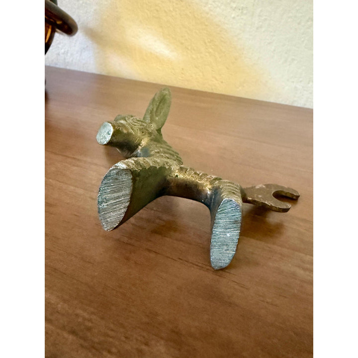 Vintage Walter Bosse brass donkey bottle opener with aged patina and Mid-Century Modern styling.
