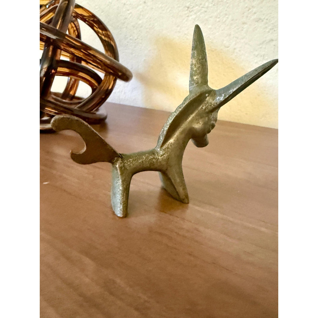 Vintage Walter Bosse brass donkey bottle opener with aged patina and Mid-Century Modern styling.