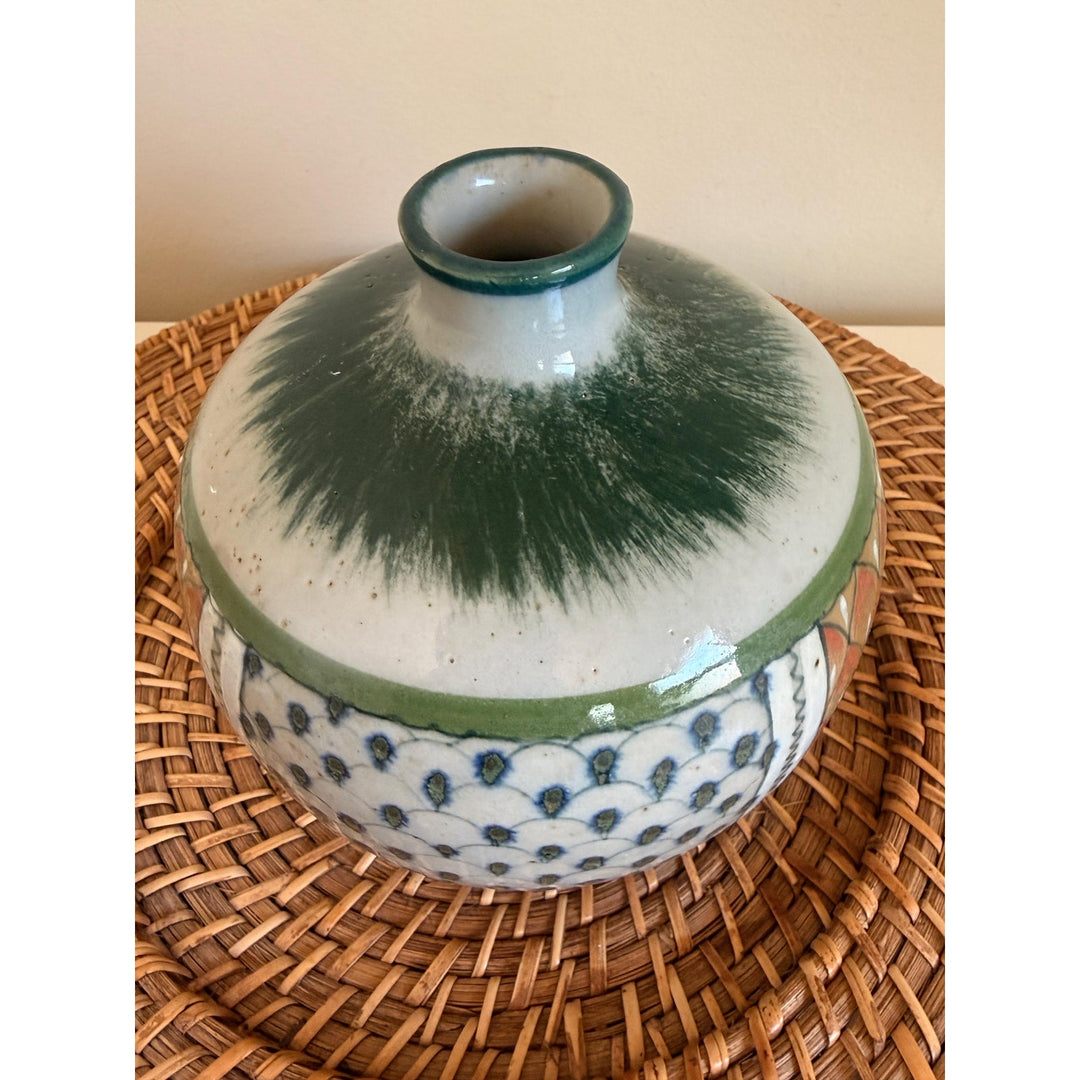 Rounded Erandi Tonalá pottery vase with hand-painted geometric patterns in blue, green, coral, and earthy neutral tones.