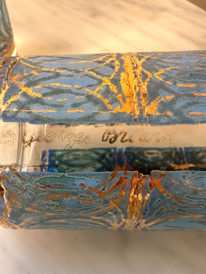 Three vintage Georges Briard highball glasses with blue interlocking oval patterns and 22-karat gold detailing.