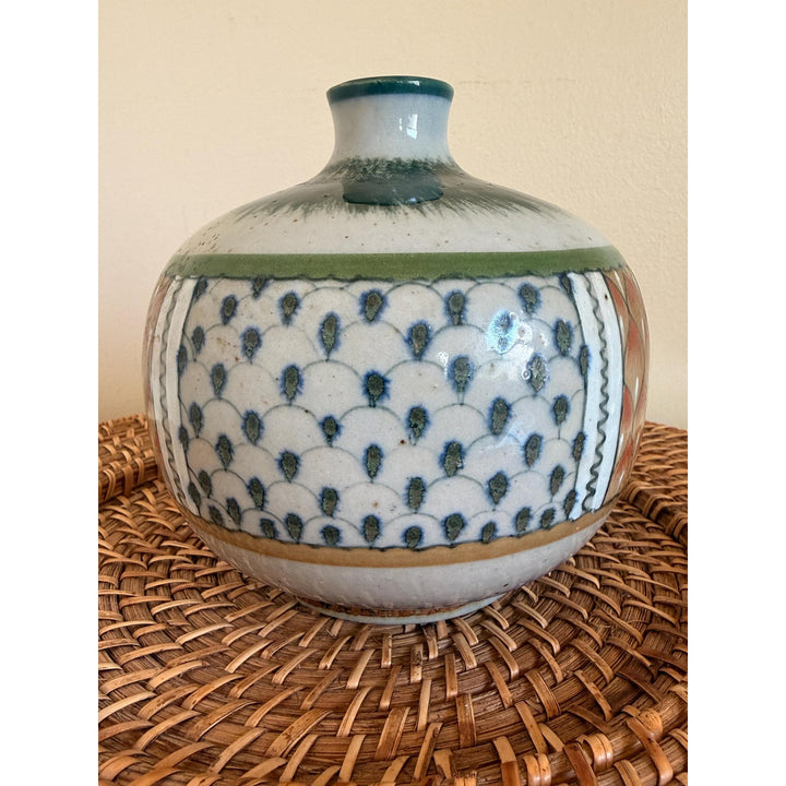 Rounded Erandi Tonalá pottery vase with hand-painted geometric patterns in blue, green, coral, and earthy neutral tones.