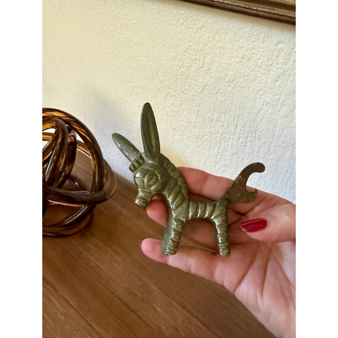 Vintage Walter Bosse brass donkey bottle opener with aged patina and Mid-Century Modern styling.
