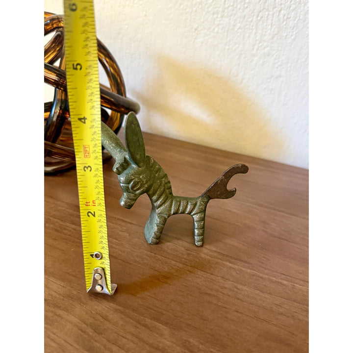 Vintage Walter Bosse brass donkey bottle opener with aged patina and Mid-Century Modern styling.