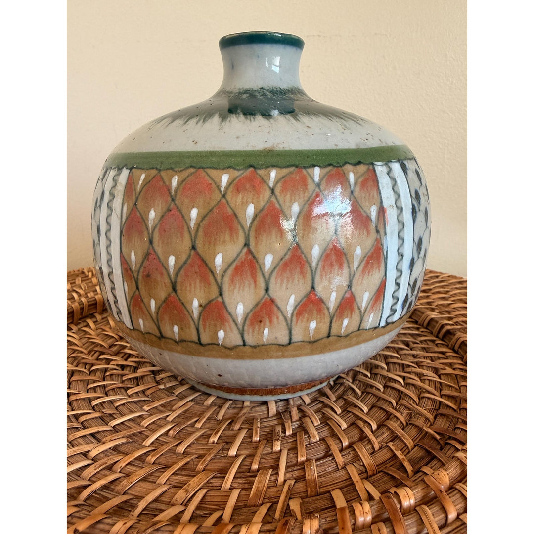 Rounded Erandi Tonalá pottery vase with hand-painted geometric patterns in blue, green, coral, and earthy neutral tones.