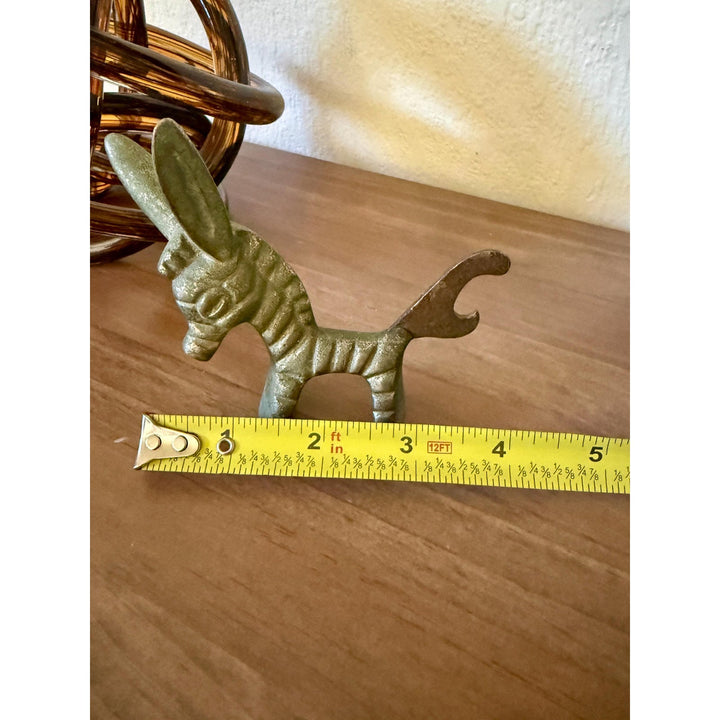 Vintage Walter Bosse brass donkey bottle opener with aged patina and Mid-Century Modern styling.